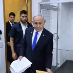 Israeli Prime Minister Benjamin Netanyahu attends his trial on corruption charges at the district court in Tel Aviv
